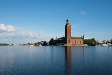 Town City hall, boats, pier and landmarks in Stockholm a tranquil morning, 