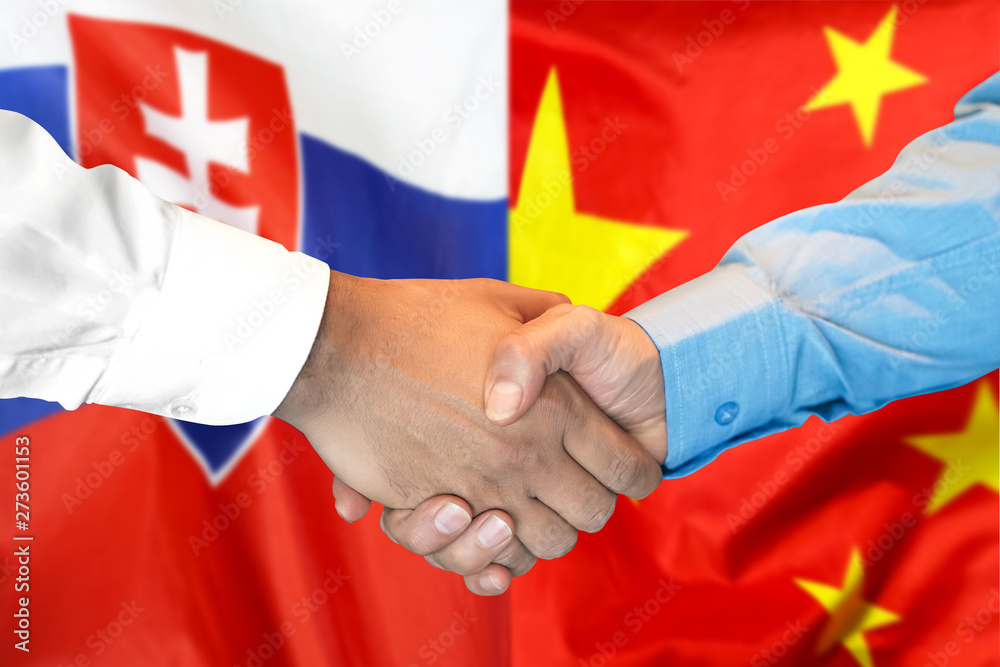 Wall mural business handshake on the background of two flags. men handshake on the background of the slovakia a