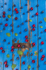 Blue wooden surface with cherries and blueberries