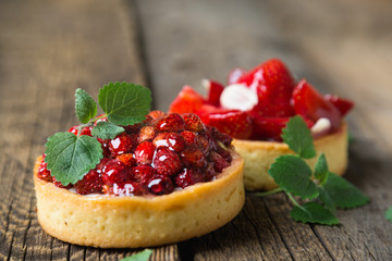 Cakes with fresh berries and mint leaves