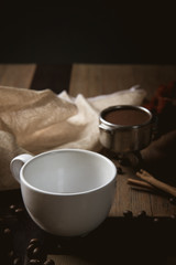 Empty cup of coffee decoration with coffee bean low light mood and tone on wooden table background