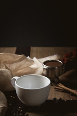 Empty cup of coffee decoration with coffee bean low light mood and tone on wooden table background