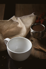 Empty cup of coffee decoration with coffee bean low light mood and tone on wooden table background