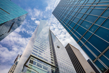 Fototapeta na wymiar New York, Manhattan. High buildings view from below against blue sky background