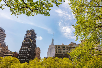 New York, Manhattan. High buildings view from below against blue sky background, sunny day in spring