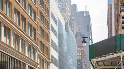 New York, Manhattan. High buildings view from below against blue sky background