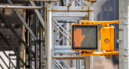 Stop, dont walk traffic sign for pedestrians, blur construction site background