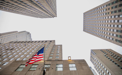 New York, Manhattan. High buildings view from below against blue sky background