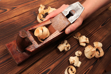 chisels plane and sawdust on a wooden table.