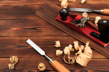 chisels plane and sawdust on a wooden table.