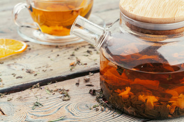 A cup with tea and teapot stand on table top view