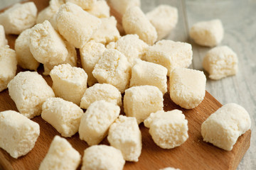 Dumplings from cottage cheese without dough. Lazy dumplings close-up on a cutting board. Cottage cheese dish for diet food. Cottage cheese dumplings.