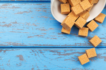 Brown cane sugar cubes isolated on white background