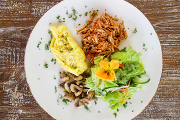 Shredded chicken served with scrambled eggs and mushrooms, Casual fine dining restaurant food	
