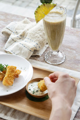 Woman having spring rolls and a delicious raw organic smoothie for the breakfast	