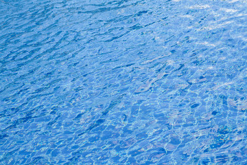 Blur of light reflecting in blue pool.