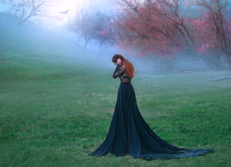 dark witch made terrible mistake, sad lady in long black dress with long tail and lace sleeves, girl with bright red orange hair pressed hands to head, autumn landscape, mysterious white haze © kharchenkoirina