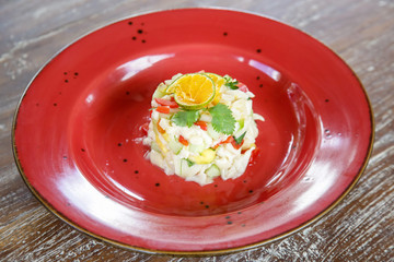 Vegetarian mushroom ceviche served on a red ceramic plate, fine casual dining concept	