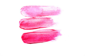 Smudged pink liquid lipstick, liquid blush isolated on white background. Concept of make up and beauty.