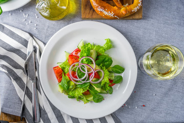 The salad with an avocado and tomatoes on a striped napkin