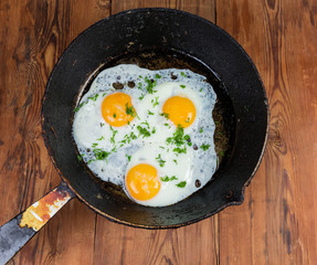 Top view of fried eggs in the frying pan