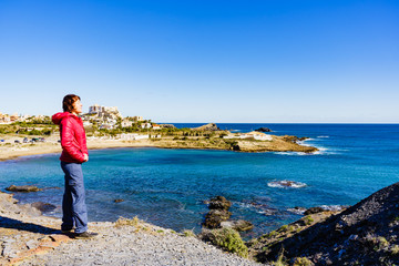 Tourist woman on sea coast in Spain