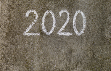 Fototapeta na wymiar Chalk text 2020 on the grey wall outdoor