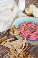 Beetroot hummus with pieces of freshly baked naan bread
