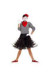 Full length portrait of a mime woman artist looking at camera isolated on white background