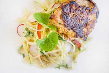 Lemongrass chicken breast with green mango salad, casual dining restaurant food