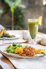 Healthy organic vegetarian dishes and glasses of detox drinks served on the restaurant table.	