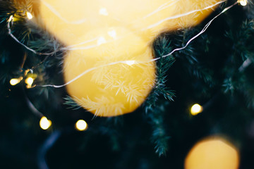 A beautiful image of a bokeh from New Year's garlands. In gold colors. Defocused glitter lighting image for art and design.