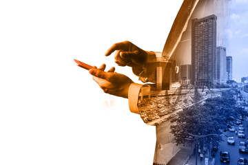 Double Exposure of Businessman hold Digital smart Tablet or Smartphone with Modern City Traffic...