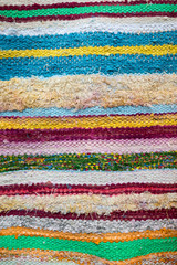 Colorful textile abstract background in a full frame close-up of imperfect woven layers