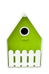Closed artificial nesting for small birds, mostly nesting in hollows. House for birds of green color on a white background. Birdhouse for birds