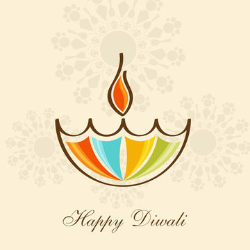 Happy Diwali concept with illuminated oil lit lamp.