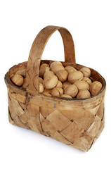 Walnuts in the basket on white background
