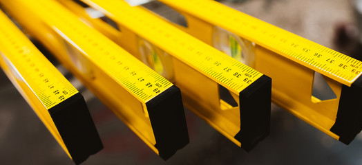 Closeup of construction level rulers displayed in the tool store. Handyman measurement instrument.