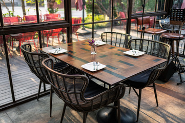 Wooden dining table and chairs in industrial modern building