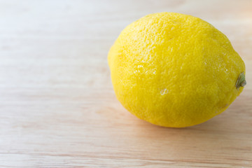 Fresh lemons on wooden background.  Top view with copy space