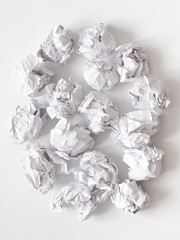 Waste reduction. Flat lay of crumpled paper ball pile on white surface. Abstract background.