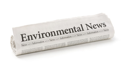 Rolled newspaper with the headline Environmental News - obrazy, fototapety, plakaty