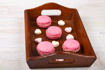 Strawberry macaroon and marshmallow on a tray