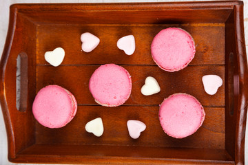 Strawberry macaroon and marshmallow on a tray