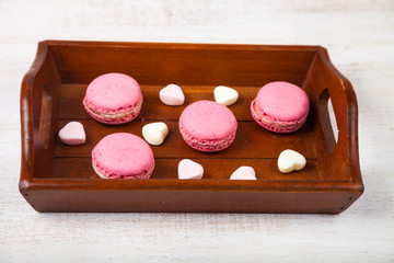 Strawberry macaroon and marshmallow on a tray