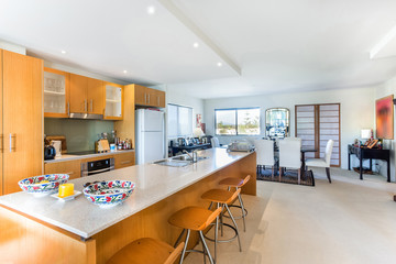 Beautiful Kitchen Area with Wooden Finish and Stools