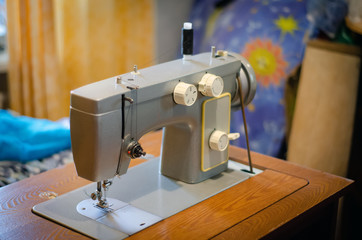 working with a black cloth on a Soviet sewing machine with black threads