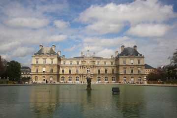Fototapeta na wymiar Reflection of fountain and the palace, Relaxation on cloudy sky in the summer at luxembourg palace, Paris, France, travel destination backgrounds