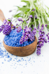 Obraz na płótnie Canvas Essential lavender salt with flowers top view.