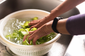 woman washing vegetables